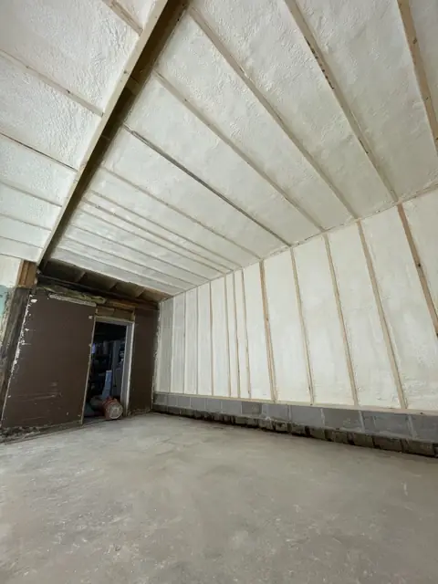 Metal building with walls and roof fully foamed