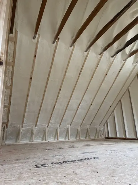Underside of a roof deck covered in closed-cell foam