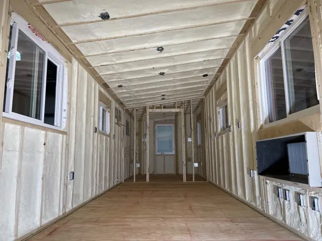 Tiny home interior with sprayed walls and ceiling